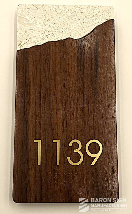 Custom wood-grain unit number sign for Omni Hotel by Baron Sign Manufacturing