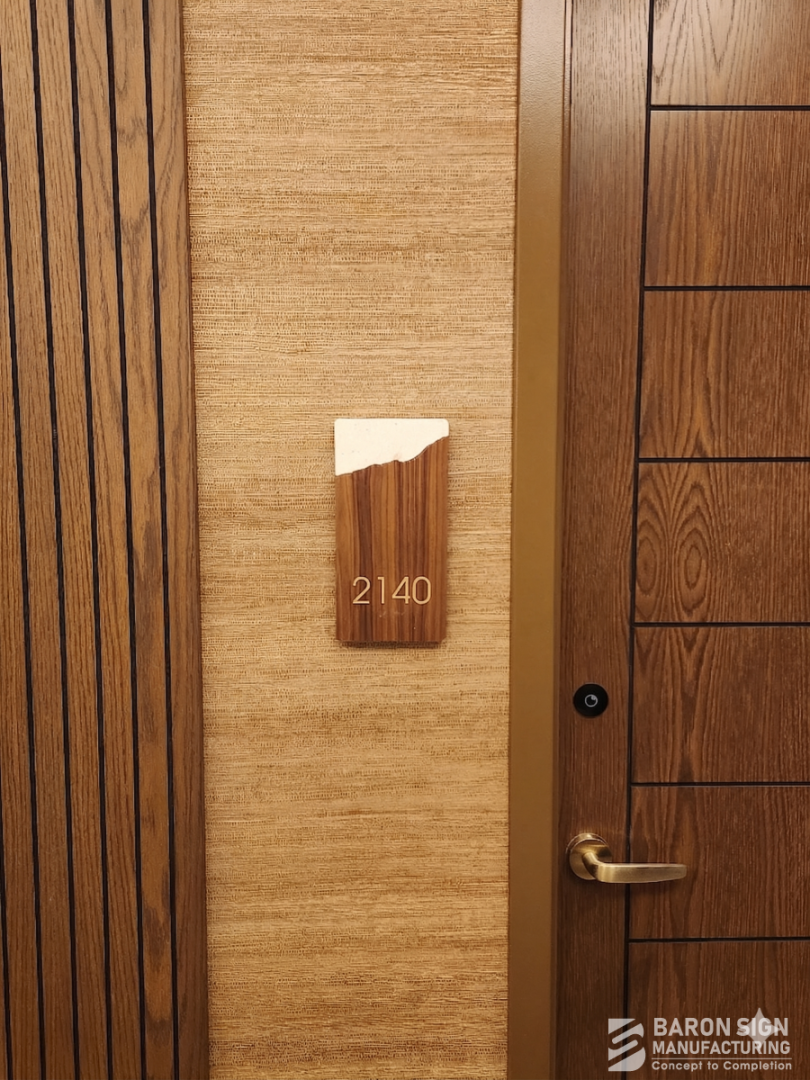 Custom wood-grain unit number sign for Omni Hotel by Baron Sign Manufacturing