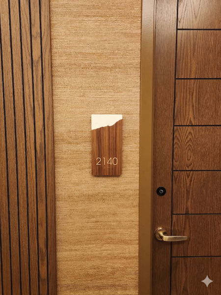 Custom wood-grain unit number sign for Omni Hotel by Baron Sign Manufacturing