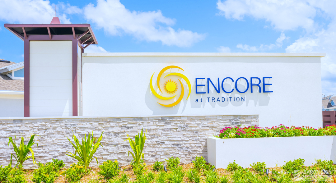 Encore at Tradition community entrance monument sign with custom horizontal orange louver screen wall and clubhouse at 8500